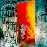 The top of the stairs and the entrance to the cells.