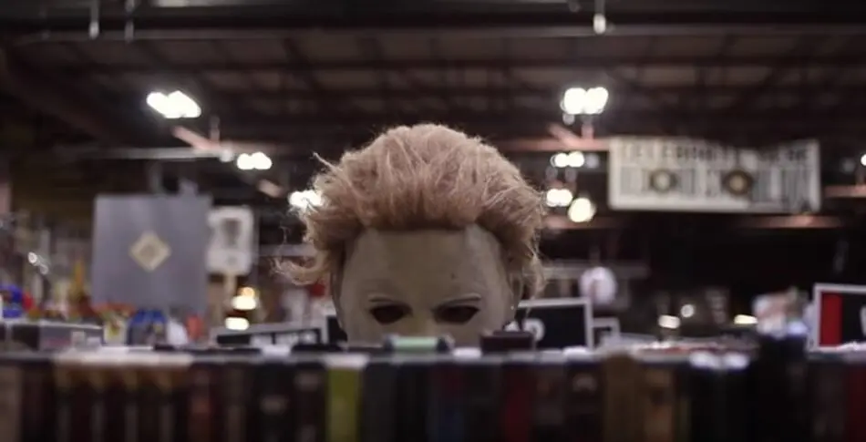 Michael Myers checking out some VHS movies at the store.