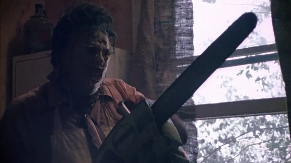 Leatherface getting his chainsaw ready in The Texas Chainsaw Massacre