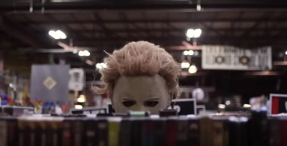 Michael Myers checking out some VHS movies at the store.