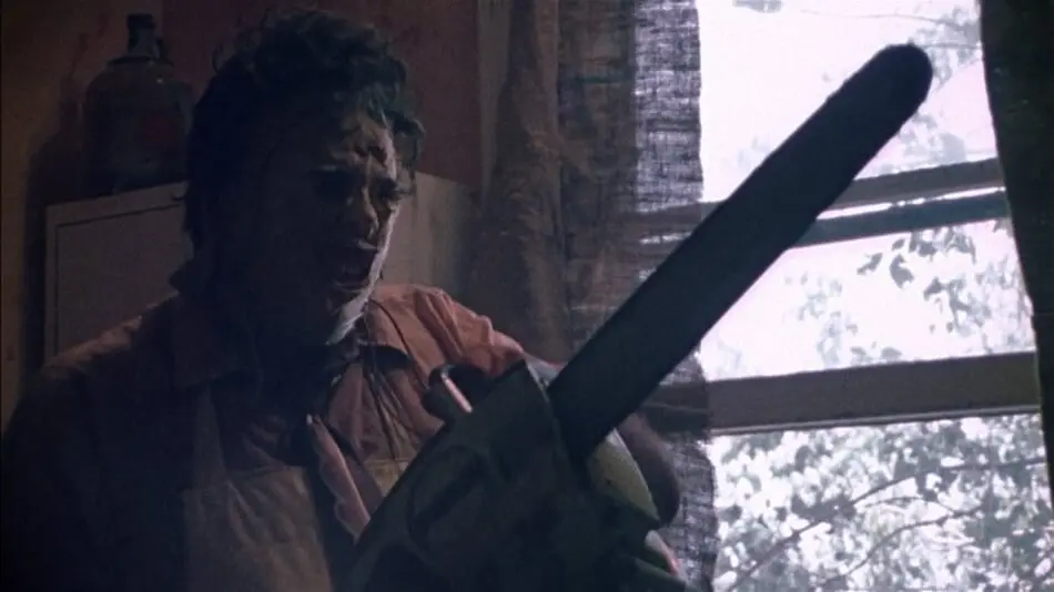 Leatherface getting his chainsaw ready in The Texas Chainsaw Massacre